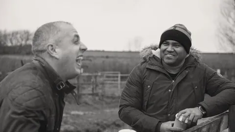 Two friends sharing a joke outside.