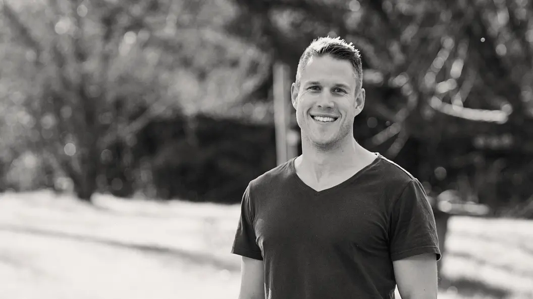 Portrait of man smiling in park.